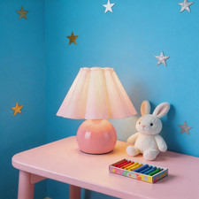 Pink table lamp with beige shade suits cozy nursery and kids' rooms.