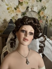 Porcelain doll, app. 22 in,  Brown hair & eyes, veil attached, ready to dress