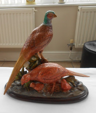 statue of two adfult pheasants and two baby ones 15 cms long 13 cms across 24 cm