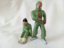 2 Vintage Lead / Metal Figurines Man on Ice Skates Lady Seated Position in Green