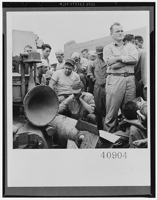 1940s Factory Workers Crowd Around Industrial Machinery Black and White Photo