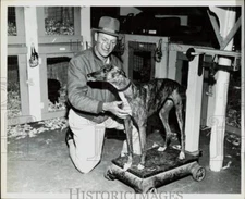 1961 Press Photo Arthur Bowser weighing his racing greyhound Rocky MacDuff