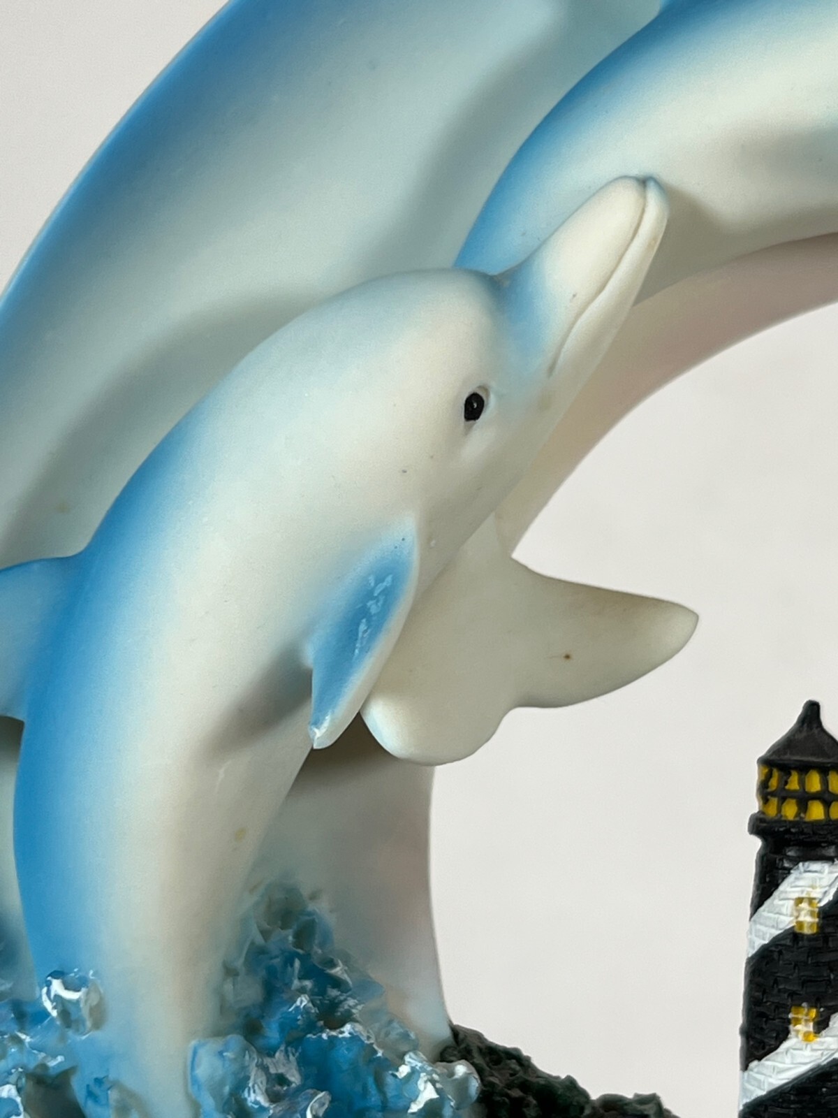 Large Ring of Dolphins swimming around a Light House