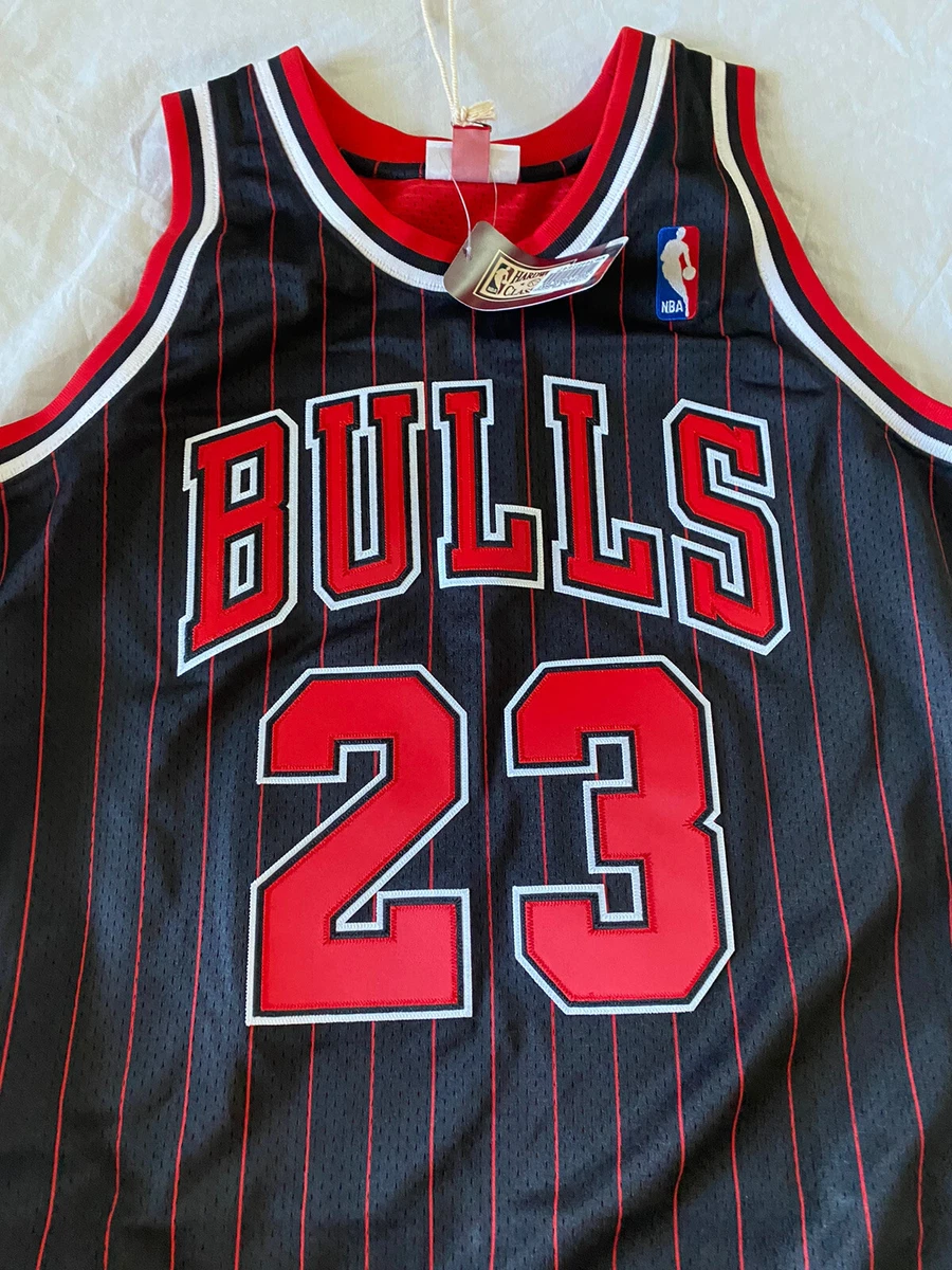 Michael Jordan in the black uniform with red pinstripes introduced