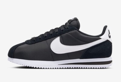 black nike trainers with white tick
