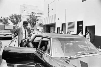 Muhammad Ali getting back into his car after meeting some of his f- Old Photo