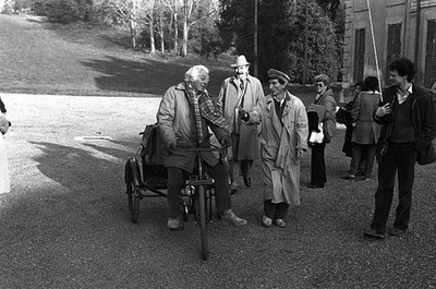 Dino Risi riding a three wheeled bicycle talking to some actors on- Old Photo