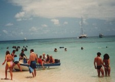 Vibrant Beach Day Colorful Swimsuits Boats in Background 1980s-90s Fun