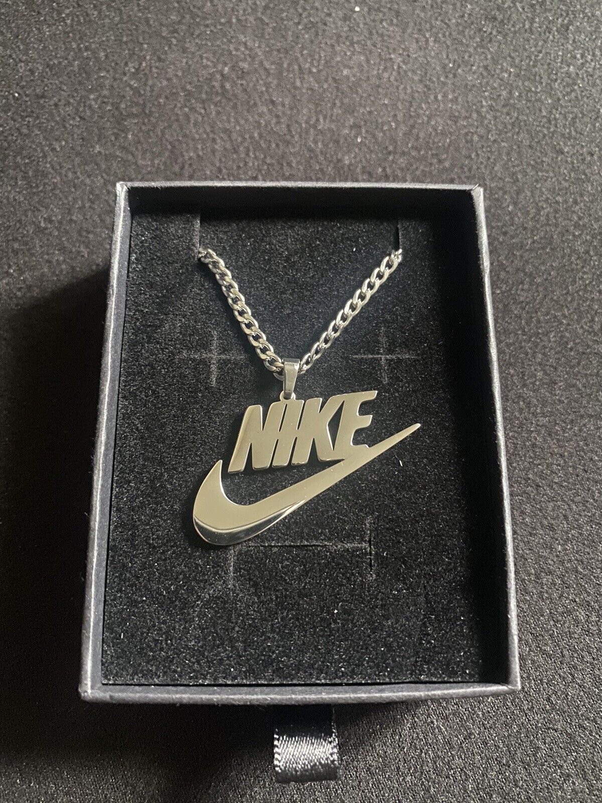 silver nike necklace