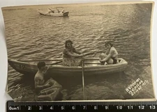 Handsome young shirtless man with girls on the beach, intimacy, Boat Old Photo