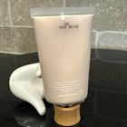 White tube of Tarte Amazonian Clay 16-Hour Full Coverage Foundation with gold cap, displayed on a white ceramic sink.