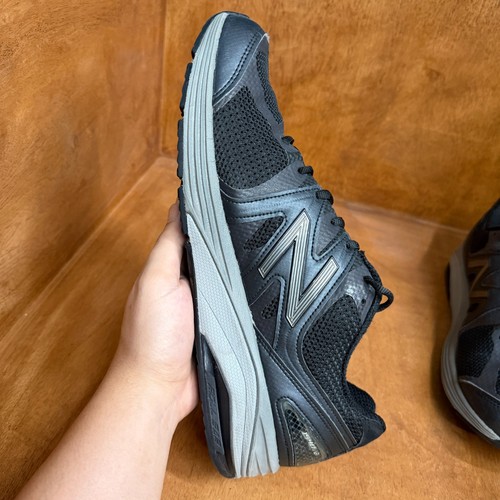 Black and gray New Balance 1540V2 men’s running shoe with mesh upper, suede overlay, and large white “N” logo on sides.