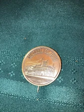 1960'S SOUTHERN COMFORT WHISKEY BRASS PADDLEWHEEL PINBACK