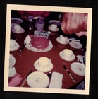 Vintage Photograph Woman Leaning Over at Table by Chocolate Birthday Cake