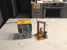 VINTAGE YONE WIND UP WORKING MECHANICAL SWINGING BABY ROBOT IN ORIGINAL BOX.