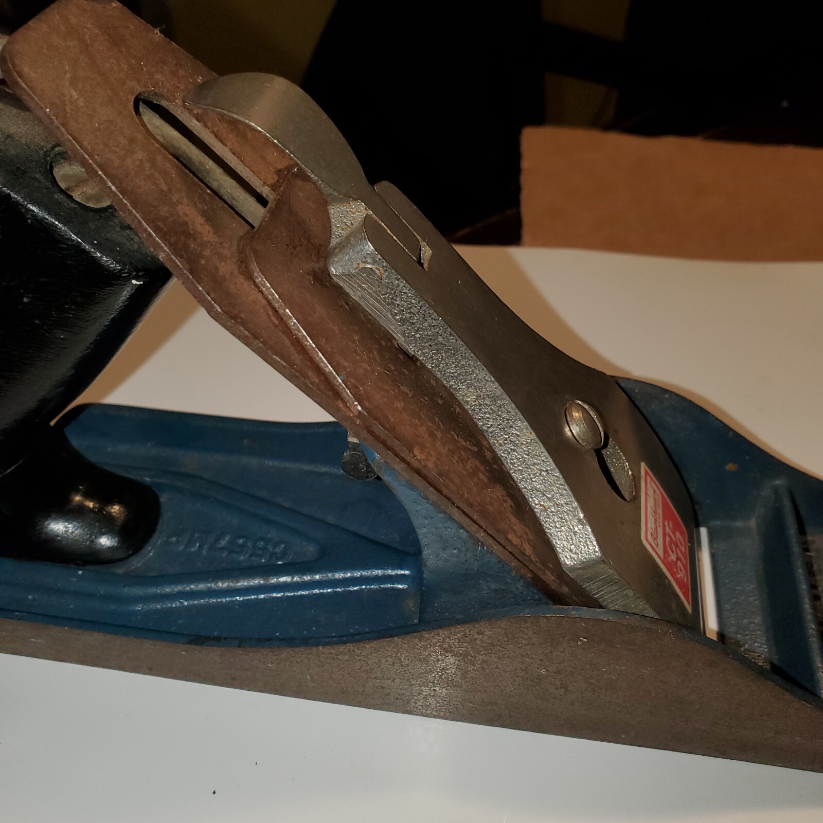 Vintage blackhawk C557MP wood hand plane with worn silver blade and dark wood handle, blue metal base, made in USA.