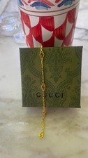 Gucci GG Gold Tone Bracelet with Interlocking GG Charms – Elegant Designer Style