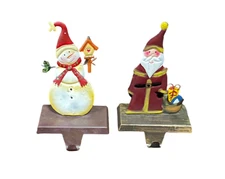 2 Christmas Holiday Metal Stocking Hangers Santa And Snowman - Preowned