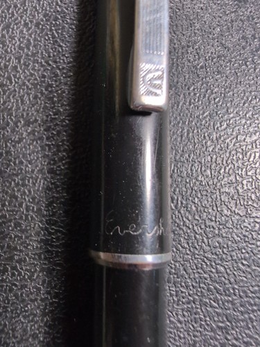 Black Eversharp mechanical pencil with silver tone trim, engraved with “Eversharp” in silver on textured surface.