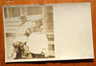 patient dog and one cross dressing owner, suillen woman real photo postcard — photo 1