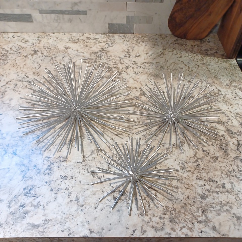 A graduated trio of silver atomic starburst/sea-urchin wall medallions — the platonic ideal of Space Age MCM cool at a steal of a price.