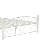 White metal bed frame with scalloped edge, featuring ornate curved footboard and headliner with raised textured floral motifs.