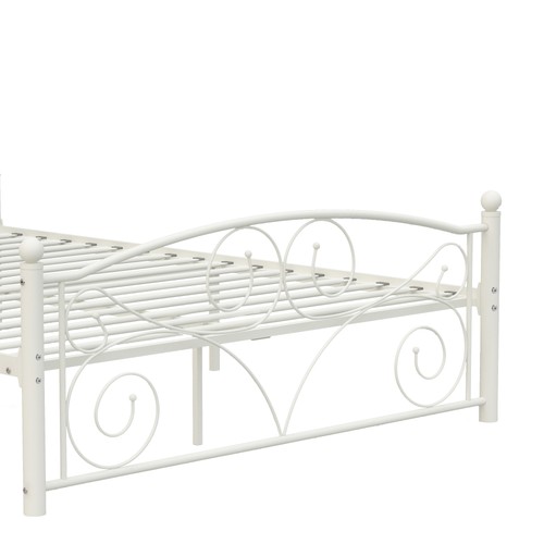 White metal bed frame with scalloped edge, featuring ornate curved footboard and headliner with raised textured floral motifs.