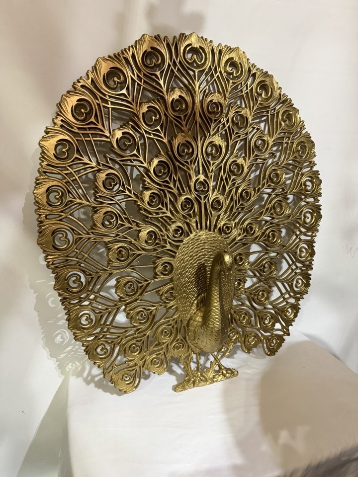XL Burwood gold feather peacock wall hanging — the kind of bold, sculptural 70s statement piece that stops guests in their tracks.