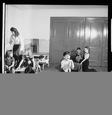New York. Children putting on their shoes after a rest period at, New York