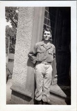 WW2 Photo Of US Soldier Smiling At Building Entrance