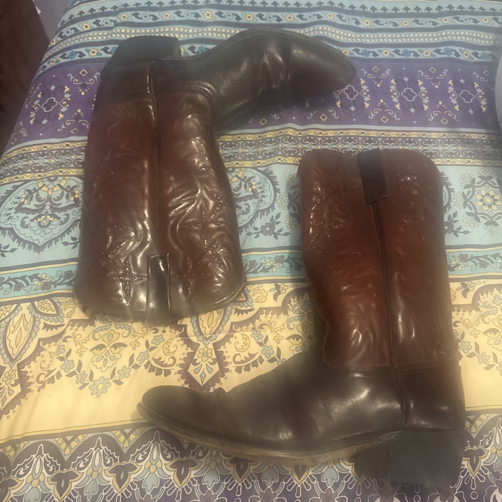 Men’s Acme leather cowboy boots with pointed toes, black heels, and white embroidered Western flame and swirl patterns.