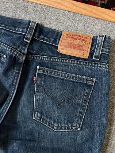 VTG 1990s Levi’s Superlow 518 dark wash bootcut jeans with tan leather patch on waistband, USA made.