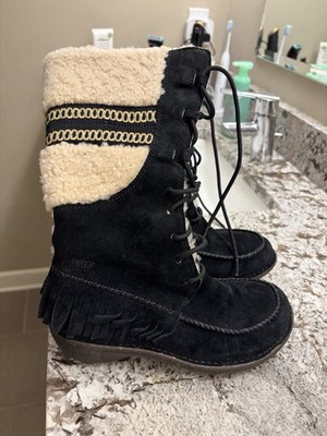 UGG Shoreline Tall Winter Boots in black suede with signature fringe detailing.