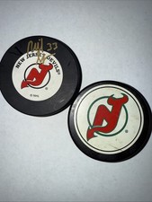 2 NEW JERSEY DEVILS NHL OFFICIAL HOCKEY PUCKS -1 Signed, #33 Reid Simpson
