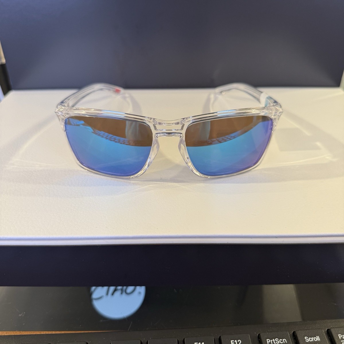 Oakley OO9448 Square Sunglasses Clear Plastic Frame Blue Mirrored