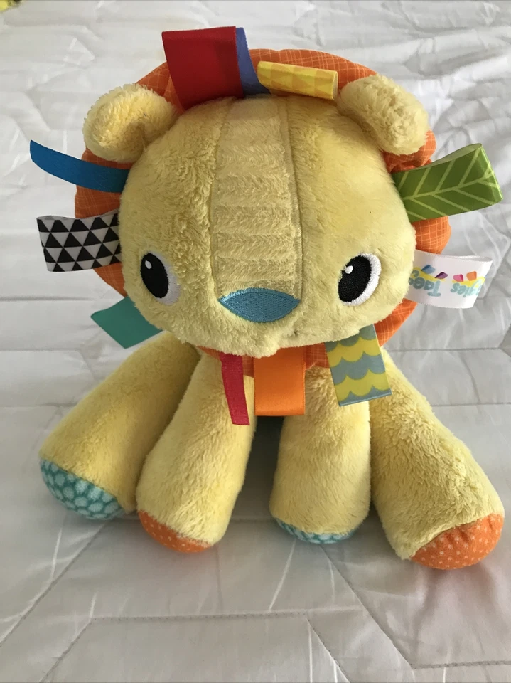 Juguete suave amarillo táctil para bebé Bright Starts Lion animal de peluche Taggies guardería 9” Foto 2 de 4