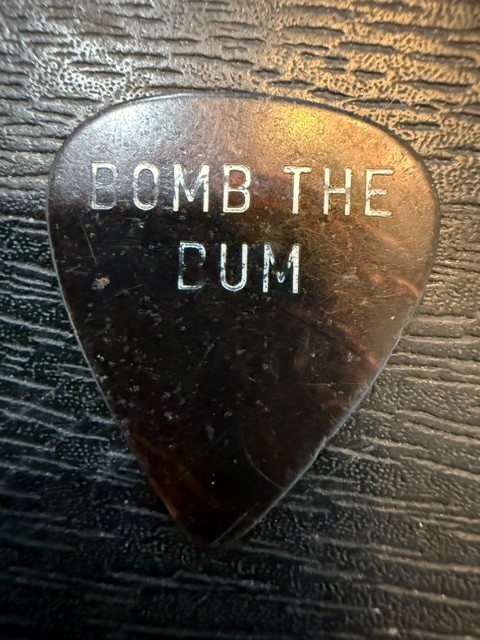 UNKNOWN /  ONE SIDED /   BOMB THE BUM ??  /  1980'S  /  TOUR GUITAR PICK