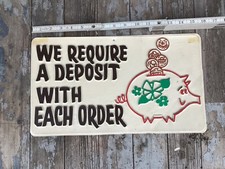 whimsical retail store sign "we require a deposit with each order  