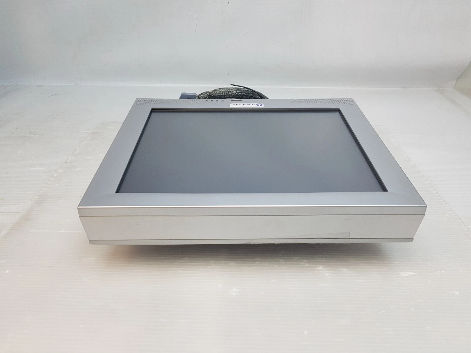 Lumenis One display lying flat, showing the screen and housing