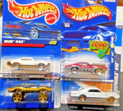 4) Oldsmobile  442's.   White 1967.     Red, Black-Lifted, & White 1970