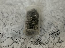 Metal Bobbins In Container Used Empty