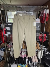 A New Day beige cotton twill chino pants feature a mid-rise fit. Size 10