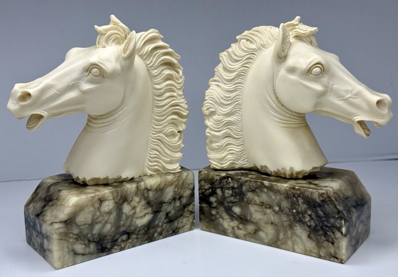 Pair of white sculpted horse head bookends with a smooth matte finish.