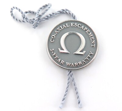 .OMEGA CO-AXIAL ESCAPEMENT 3 YEAR WARRANTY GENUINE SWING TAG.