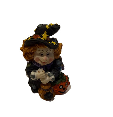Halloween witch figurine with broom and pumpkin