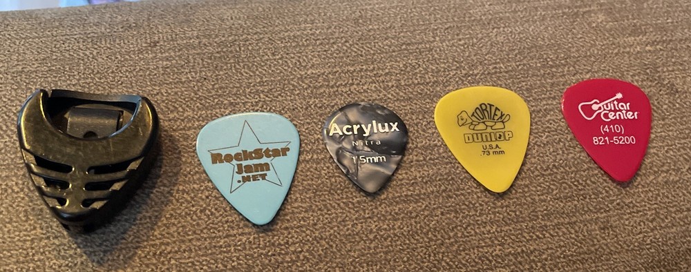 Assorted Lot of 4 Guitar Picks Plus Holder
