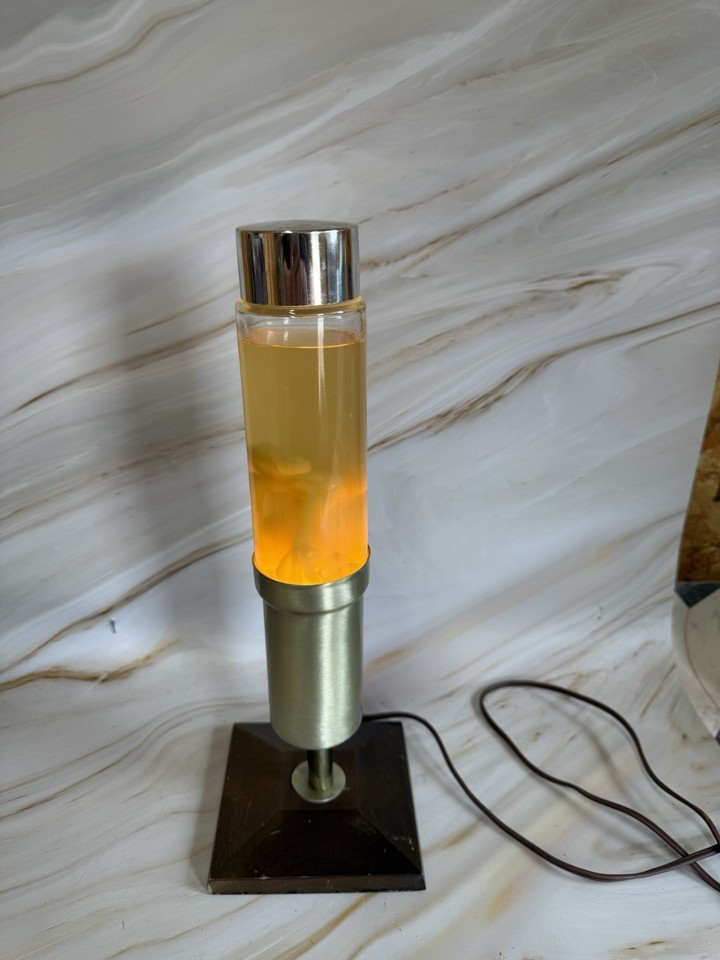 A working vintage Consort lava lamp in orange and yellow — the real McCoy MCM piece that modern reproductions can't touch.