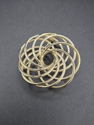 gold-tone swirl or spirograph-style brooch pin