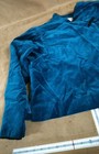 Doncaster blue velvet jacket with long sleeves, high collar, and subtle textured pattern, shown flat beside a ruler.