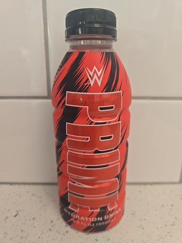 Prime Hydration Drink WWE Red & Black Bottle 16.9 FL OZ In Hand